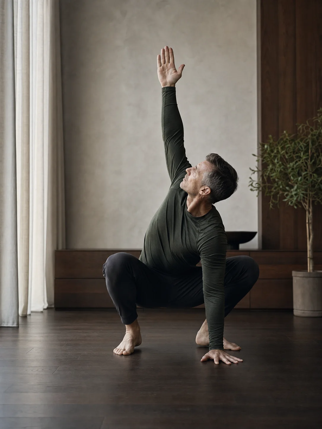 Man performing a deep-squat thoracic mobility reach